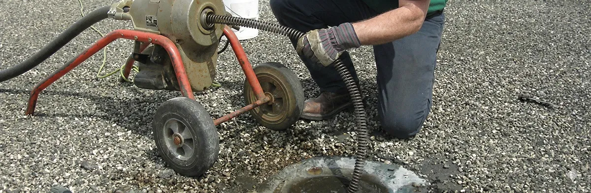 sewer rodding technician actively removing blockages from a sewer line in Buffalo, NY